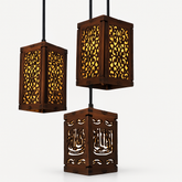Three wooden pendant lights with intricate carvings on a white background
