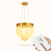 Gold pendant light with remote control on a white background