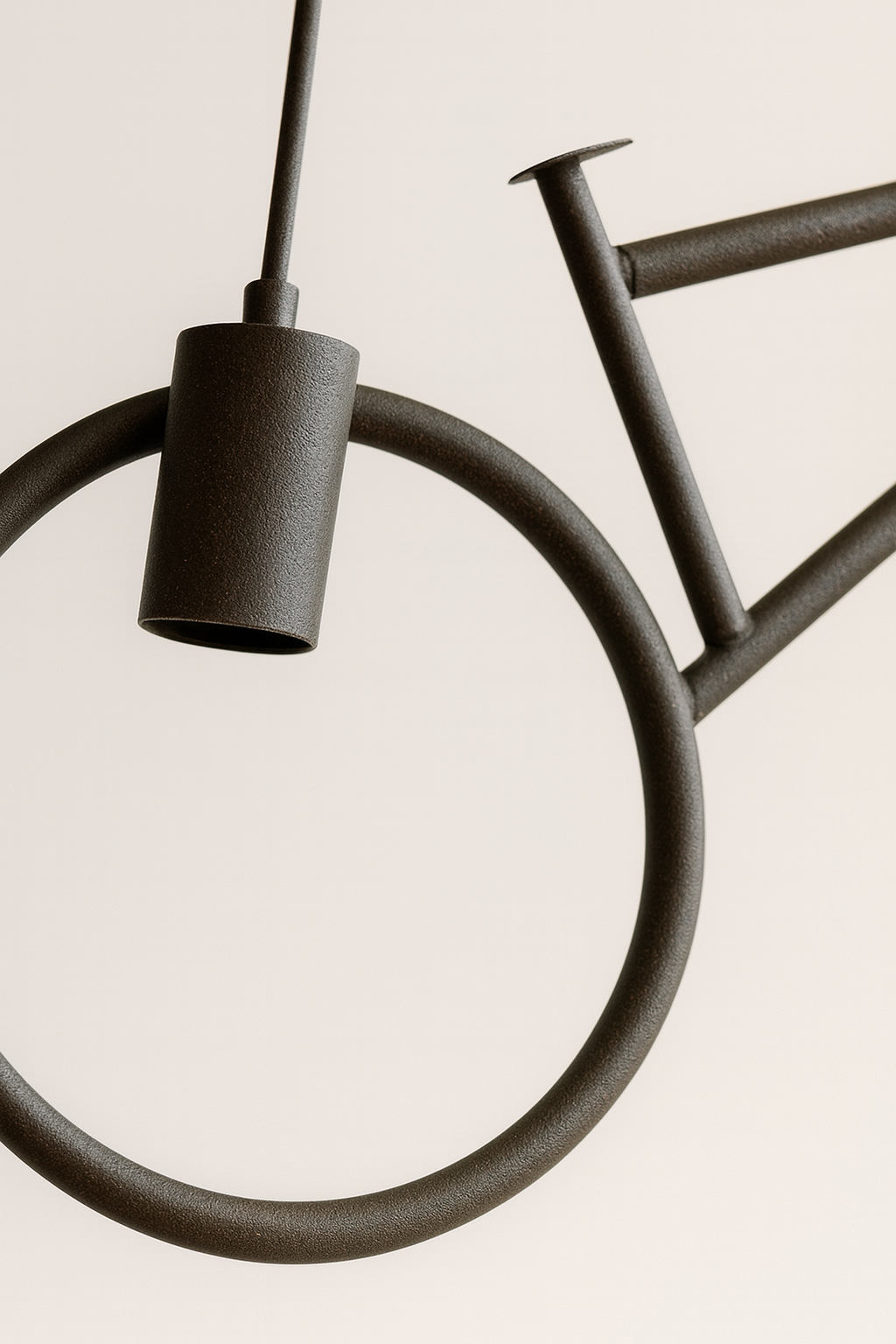 Close-up of a black bicycle on a light beige background