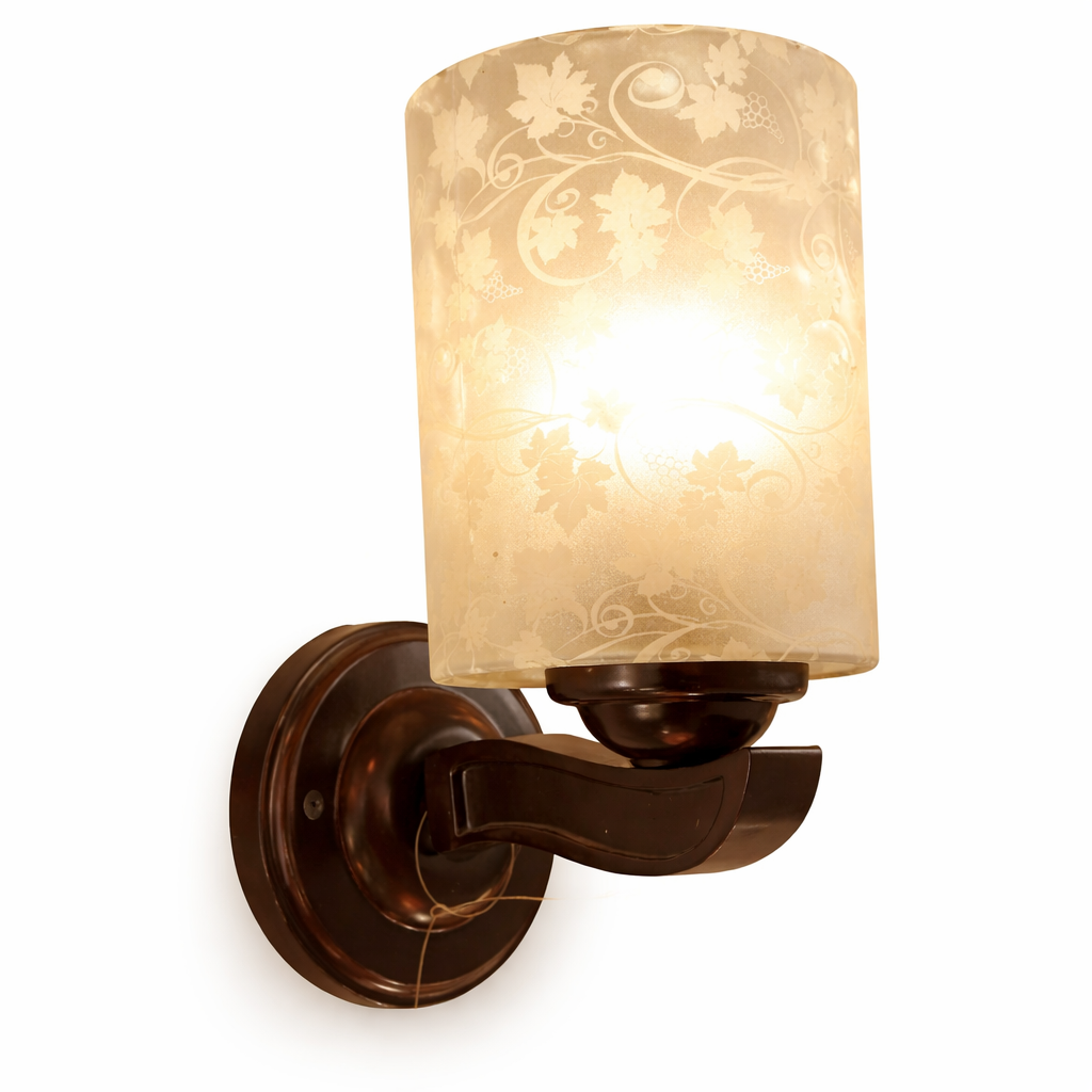 Decorative wall sconce with frosted glass and warm golden glow