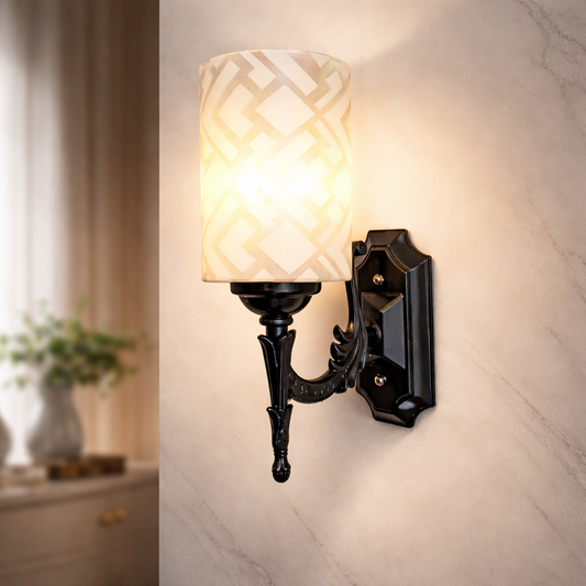 Modern wall sconce with patterned shade glowing warm light
