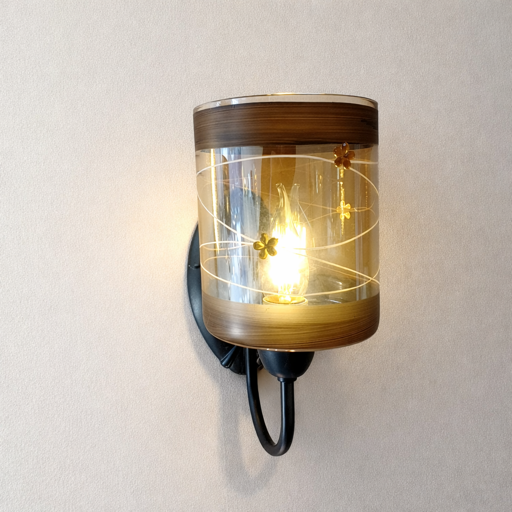 Wall-mounted light fixture with glass shade on a plain wall