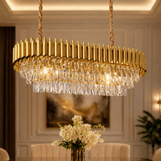 Gold chandelier hanging in a room with a vase of flowers on a table.