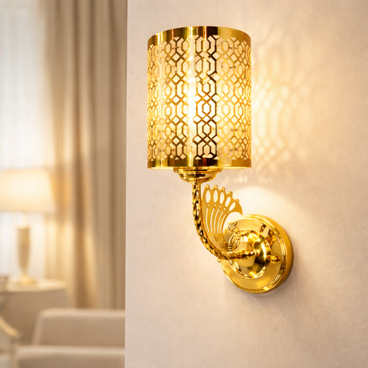 Gold wall sconce light with geometric pattern glowing warmly indoors