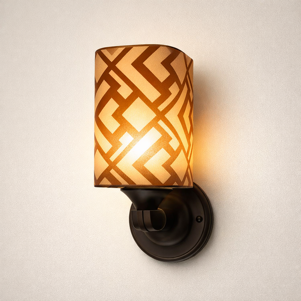 Modern wall light with patterned glass shade and warm glow