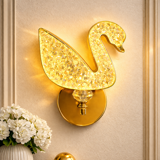 gold crystal swan wall light glowing on modern bedroom wall