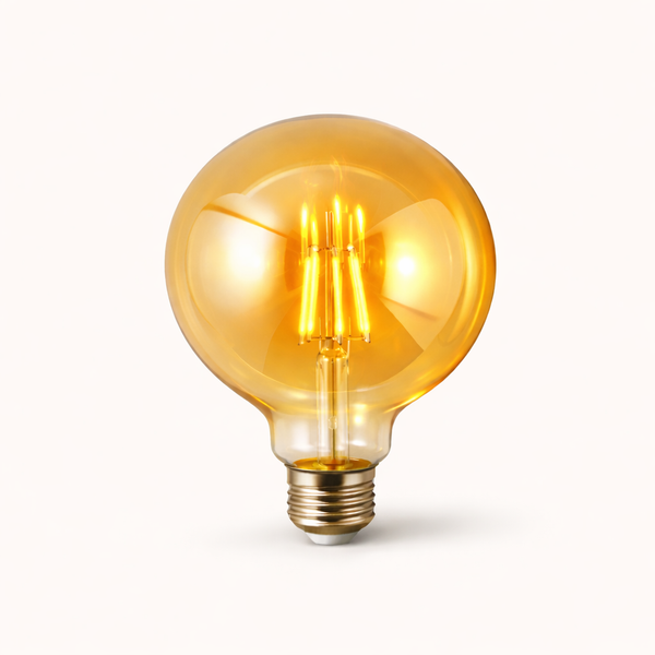 “Amber LED filament bulb glass globe with warm golden glow”