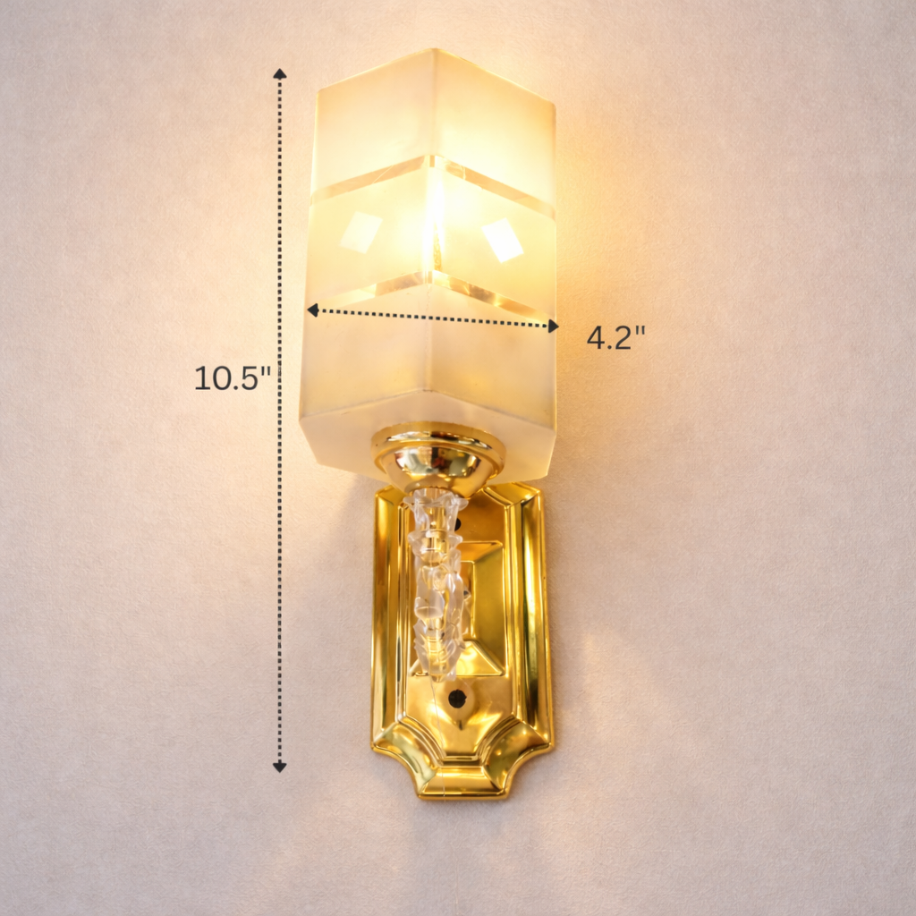 Gold wall sconce with measurements on a light gray background