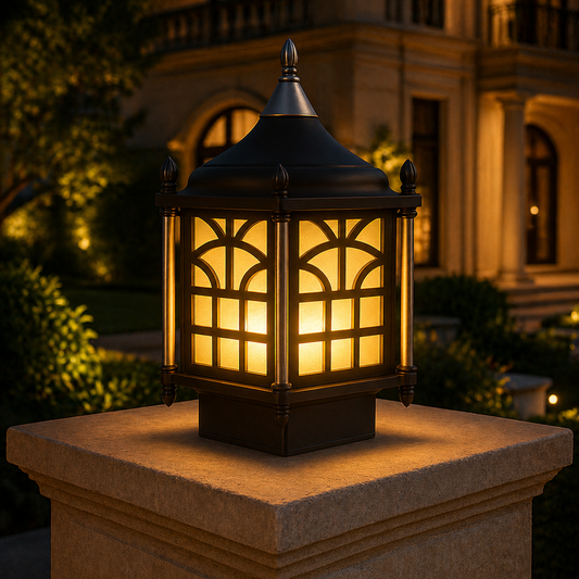 Decorative outdoor lantern on a pedestal in front of a building at night.