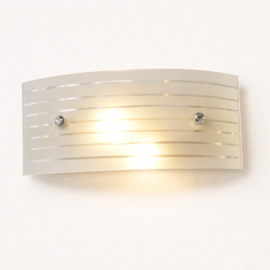 Modern glass wall light fixture with warm golden glow