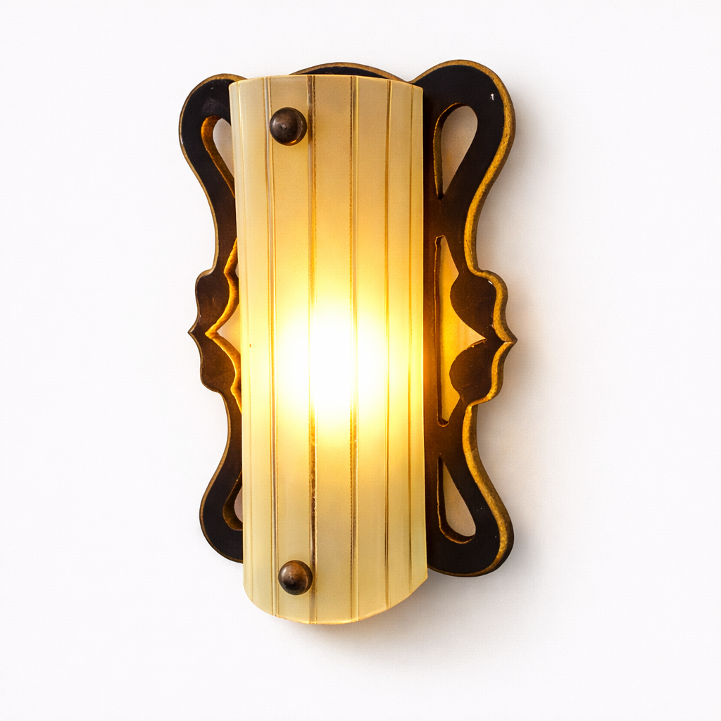 Decorative wall sconce with a warm glow on a white background