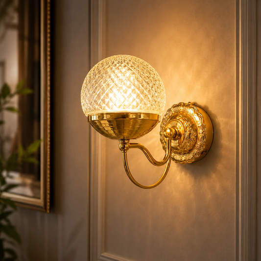 Decorative wall lamp with textured glass shade and gold fixture on a wall.