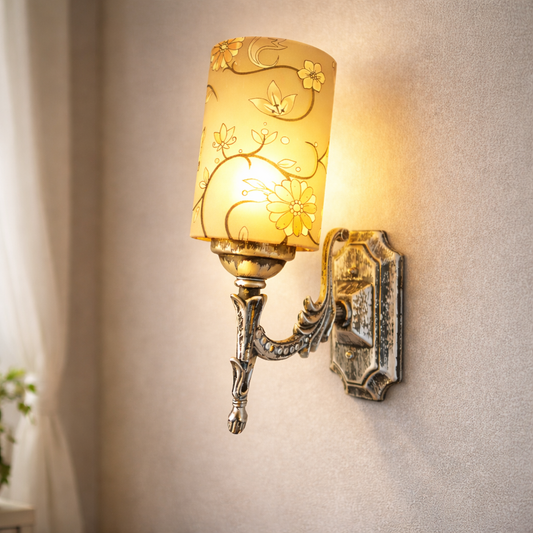 Vintage wall sconce with floral shade glowing on bedroom wall