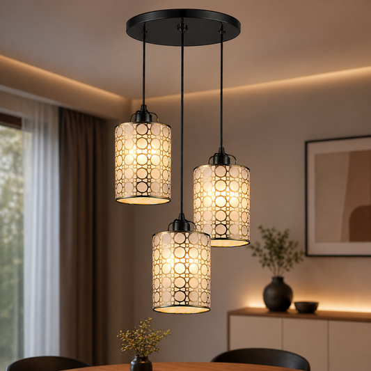 Three pendant lights hanging above a table in a room with a window and decorative items.