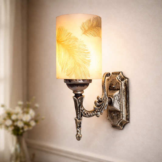 Vintage wall sconce with feather shade glowing on bedroom wall