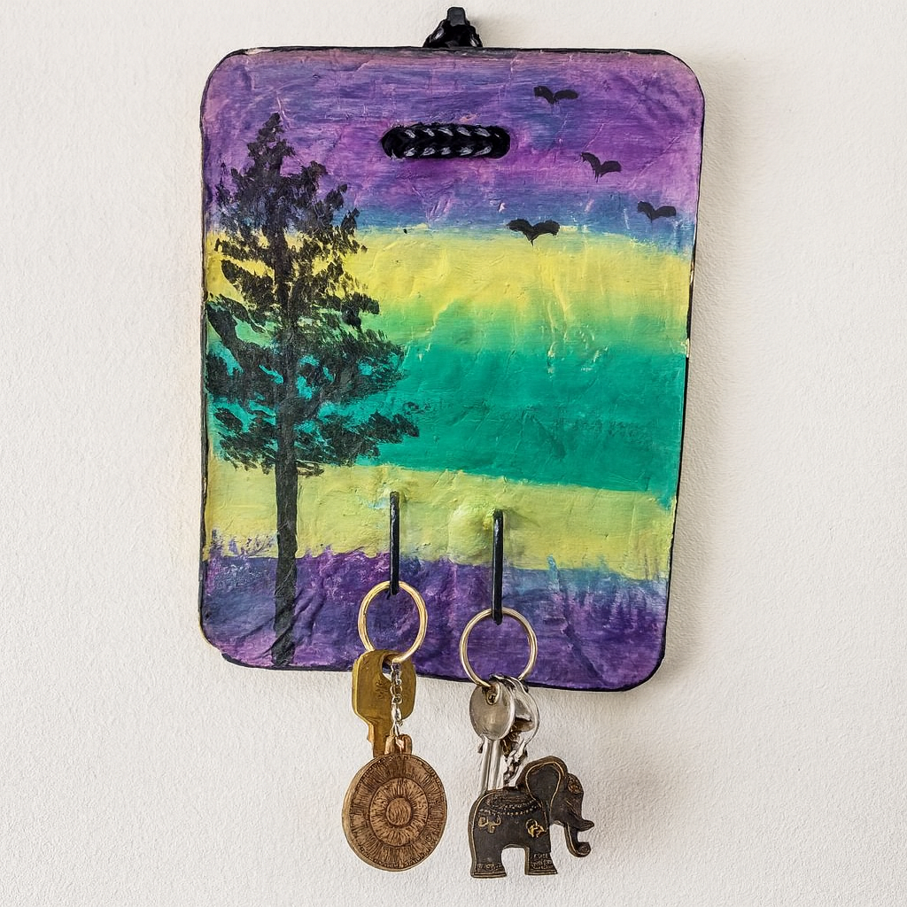 Key holder with colorful landscape design on a white wall