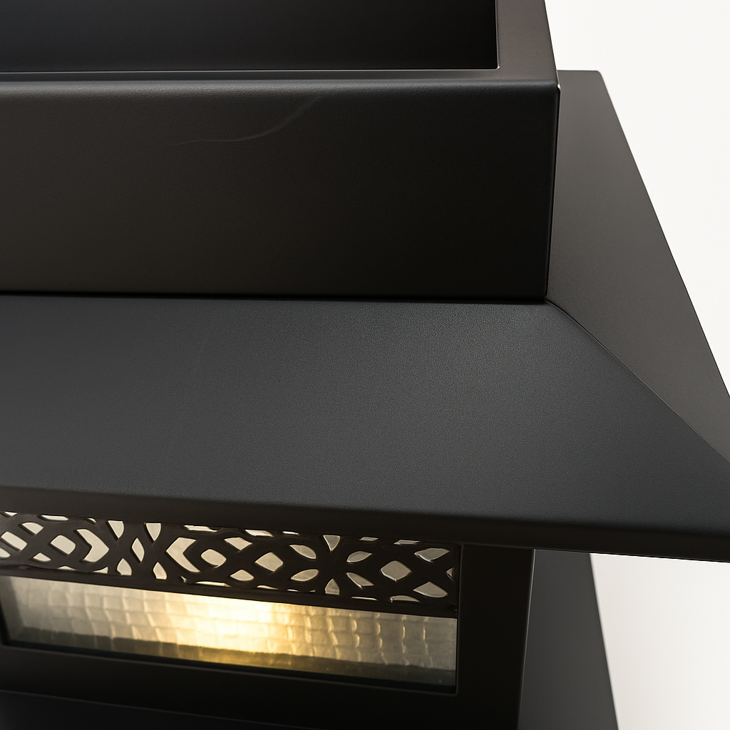 Black outdoor lamp with decorative cutout design on a white background