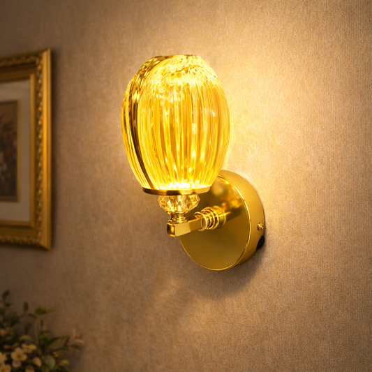 Gold wall lamp with ribbed glass shade glowing warmly indoors