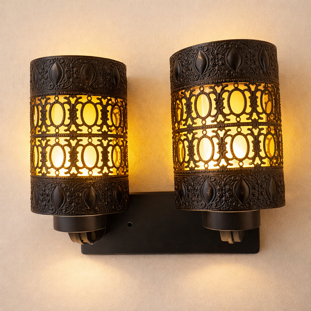 Luxury gold wall sconce with dual metal shades glowing warmly