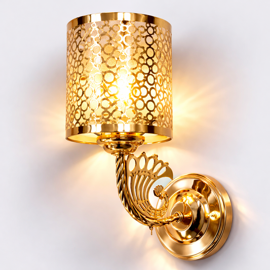 Gold wall sconce with intricate design on a white background