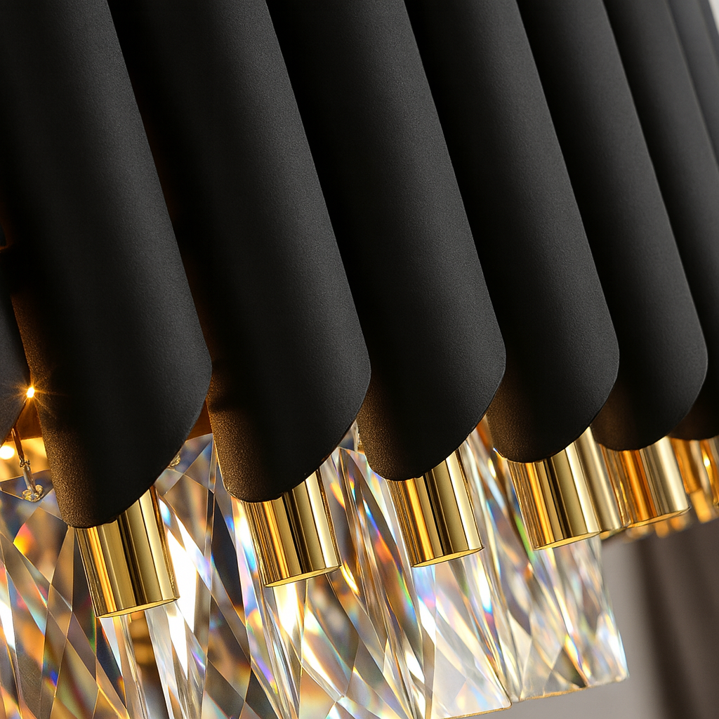 Black and gold pendant lights with crystal accents on a reflective surface.