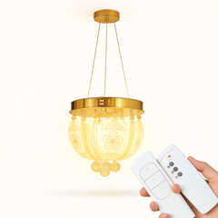 Gold pendant light with remote control on a white background