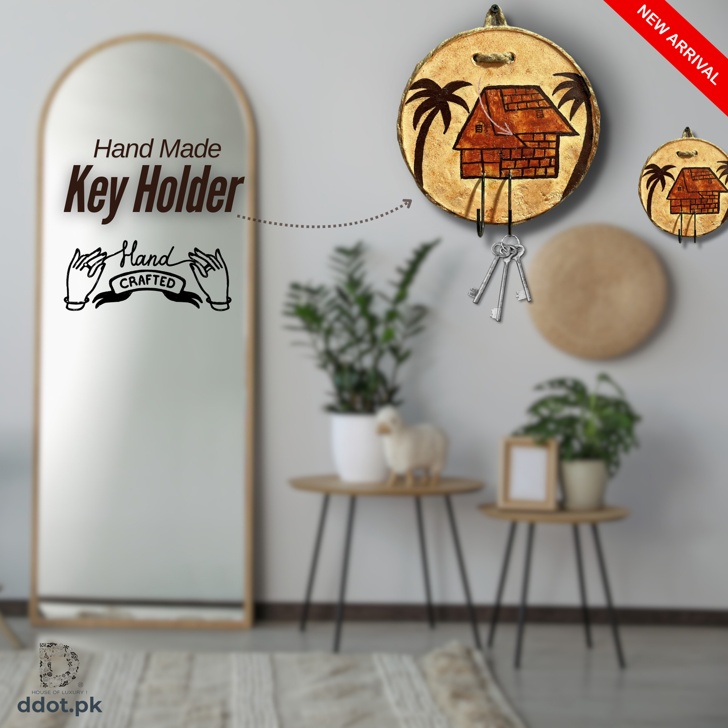 A handmade wooden keys holder with a jute border, displayed on a wall above a mirror, with a small decorative house icon on the top. The holder is brown with a white palm tree design, and there are keys hanging from it.