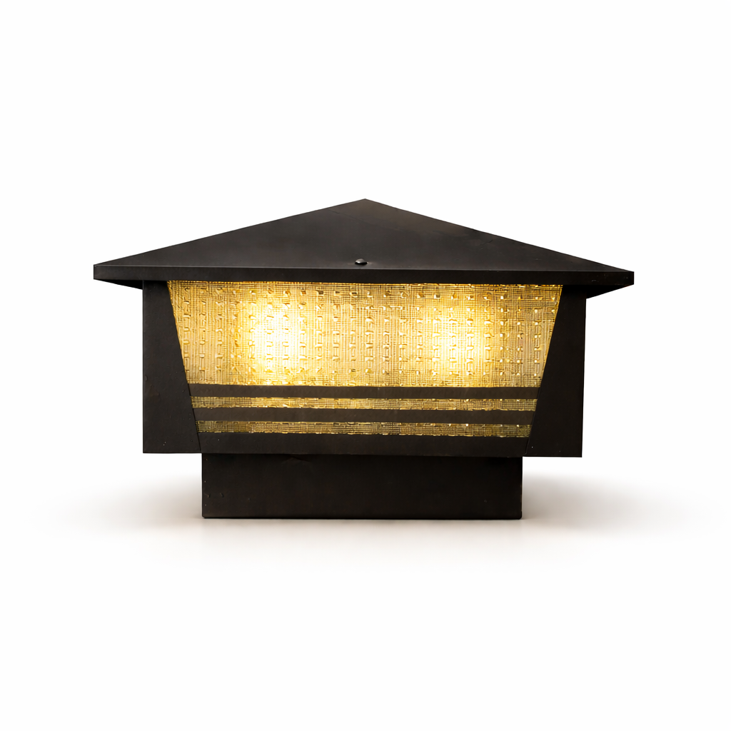 Black metal outdoor post cap light glowing warm