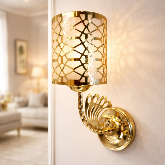 Gold wall sconce light installed on modern bedroom wall