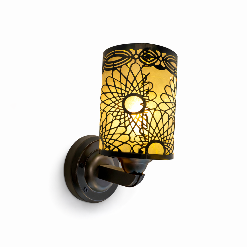 Modern wall sconce light with filigree shade and warm glow