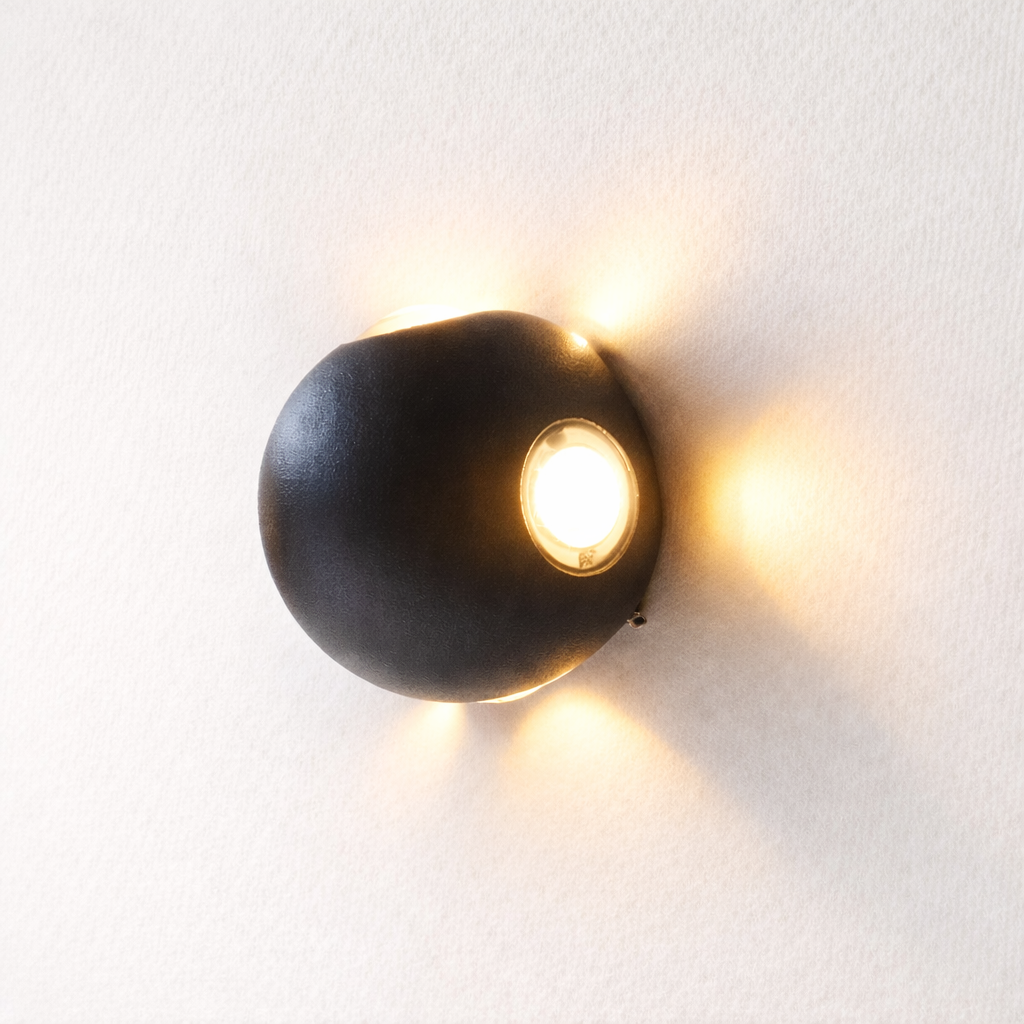 Modern wall-mounted light fixture on a white wall