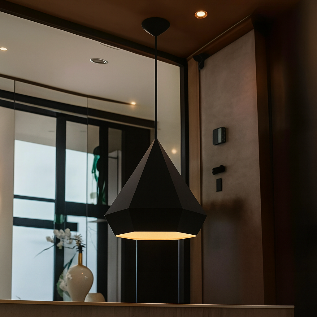 Modern black pendant light hanging in a room with a mirror and decorative items.