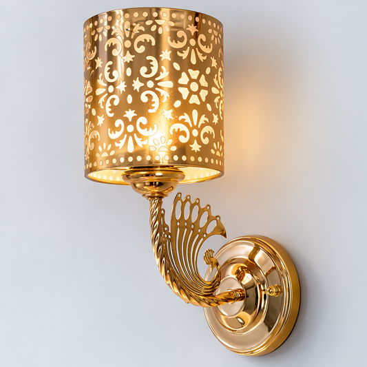 Gold wall sconce with intricate design on a white background