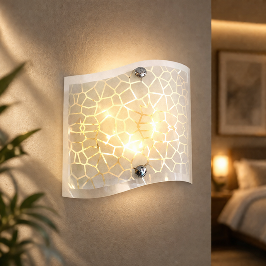 Modern white glass wall sconce glowing on textured bedroom wall