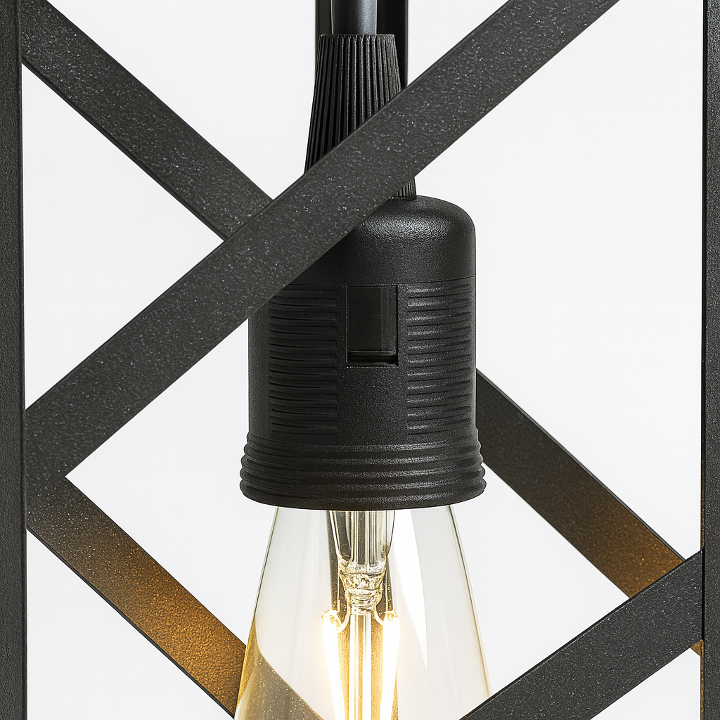 Close-up of a black light fixture with a clear bulb against a geometric patterned background.