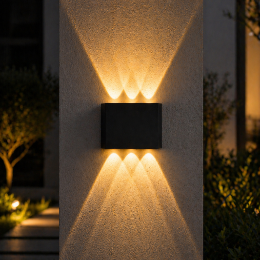 Modern outdoor wall light fixture on a house exterior with warm glow