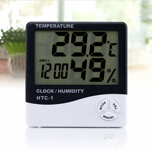Digital thermometer and humidity meter with clock function on a blurred background