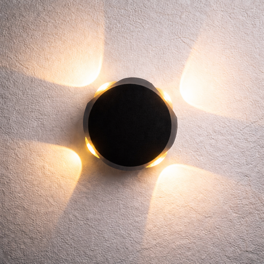 Round wall light fixture on a textured white wall