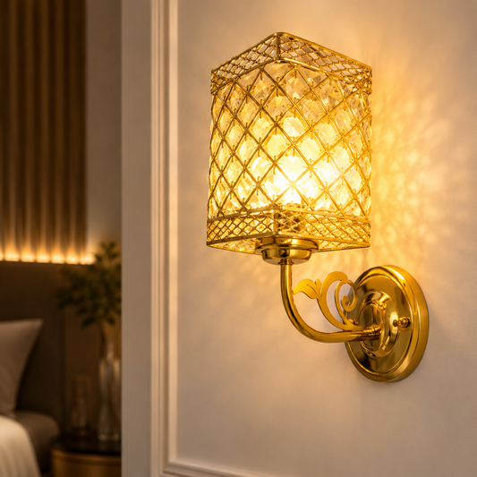 Gold wall sconce with textured glass shade on a wall in a room setting.