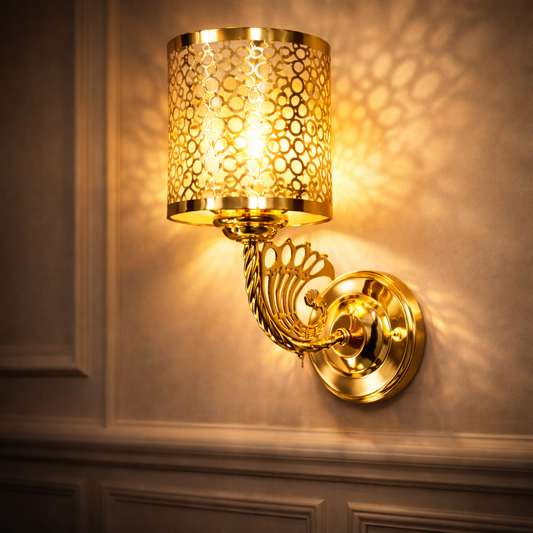 gold wall sconce light installed on bedroom wall with warm glow