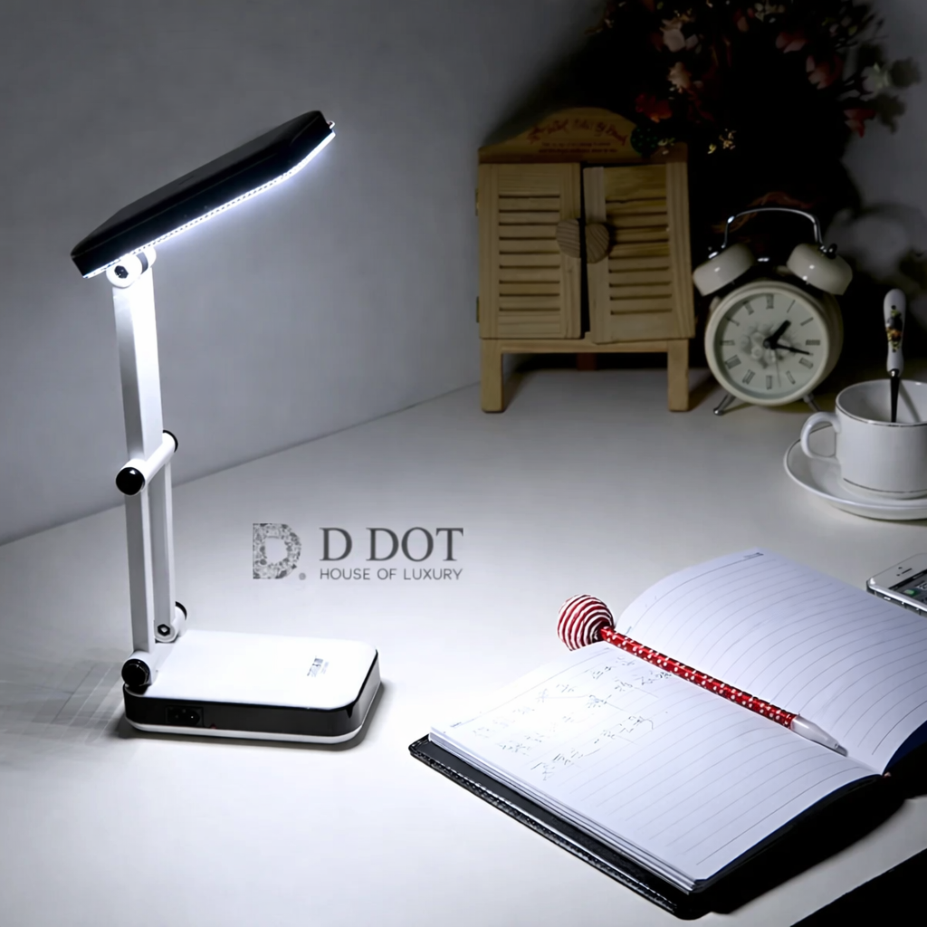 Desk lamp on a desk with a notebook, pen, and clock in the background.