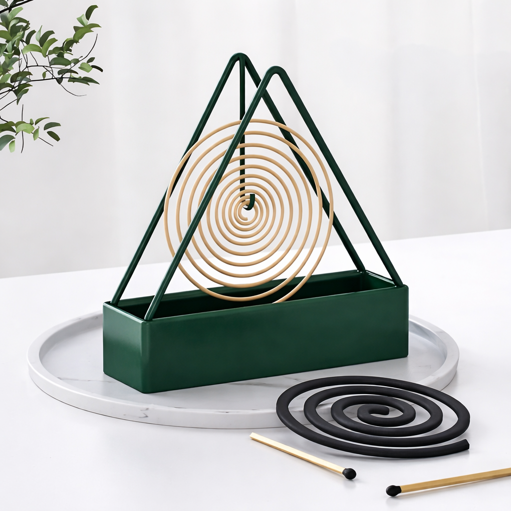 Triangular incense holder with spiral incense on a white surface