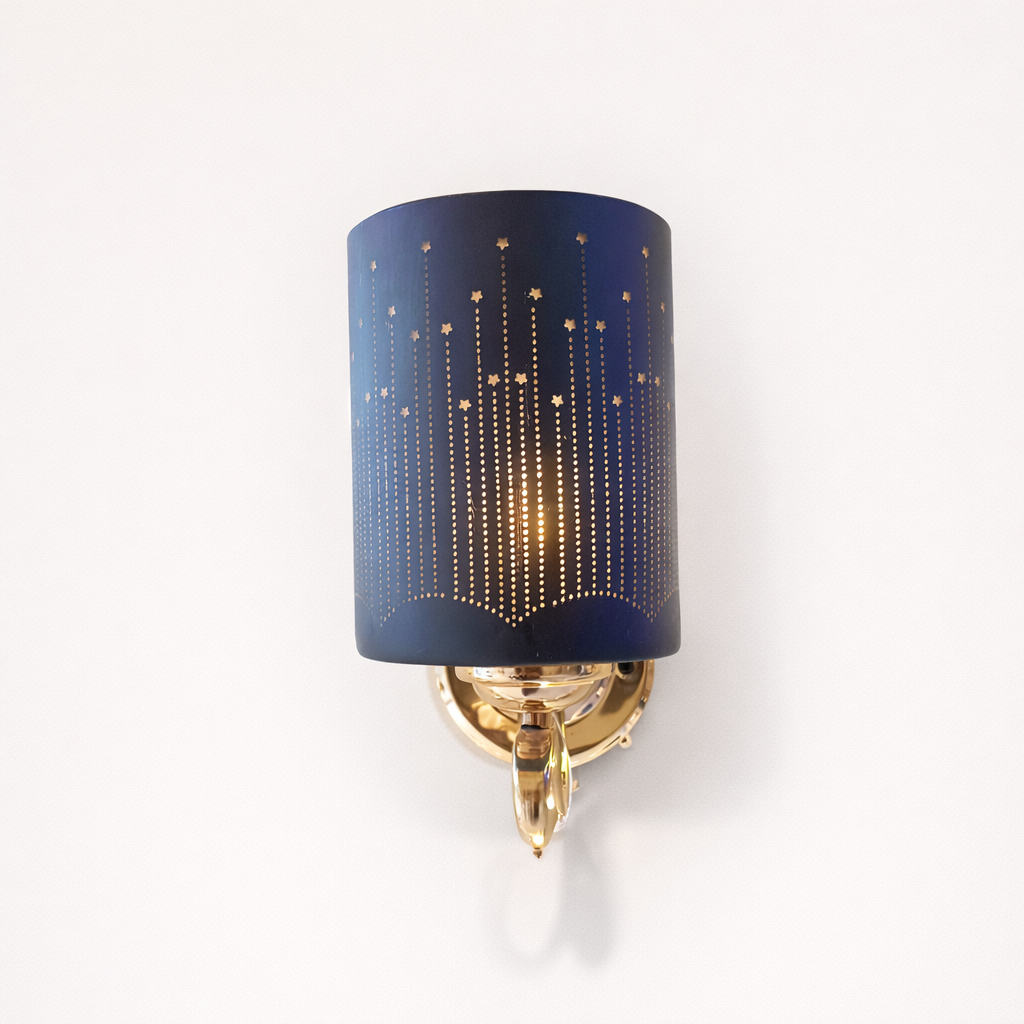 Wall sconce with blue shade and gold base on a white background