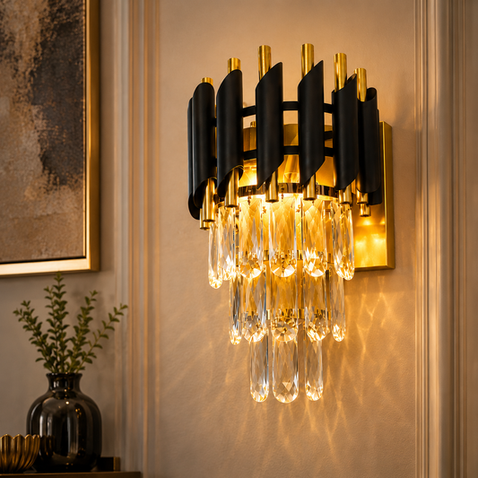 Modern wall light fixture with black and gold design on a wall.