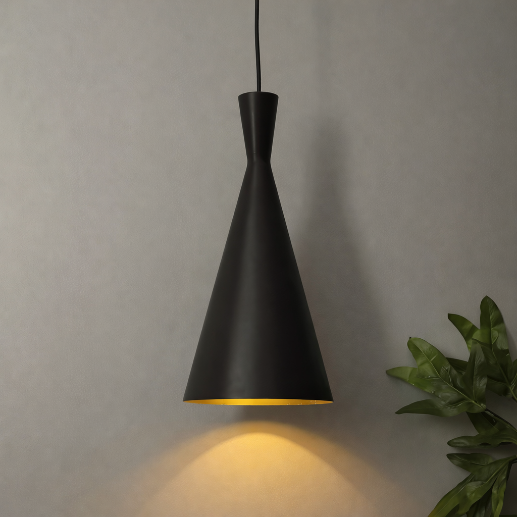 Black pendant light with a warm glow on a plain wall background