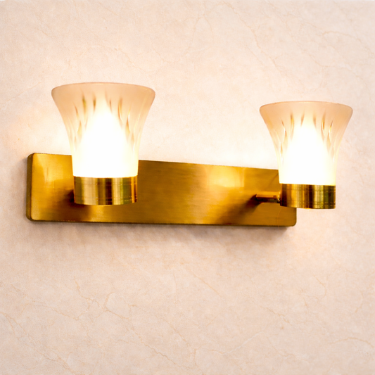 Gold wall sconce with two lights on a light beige wall